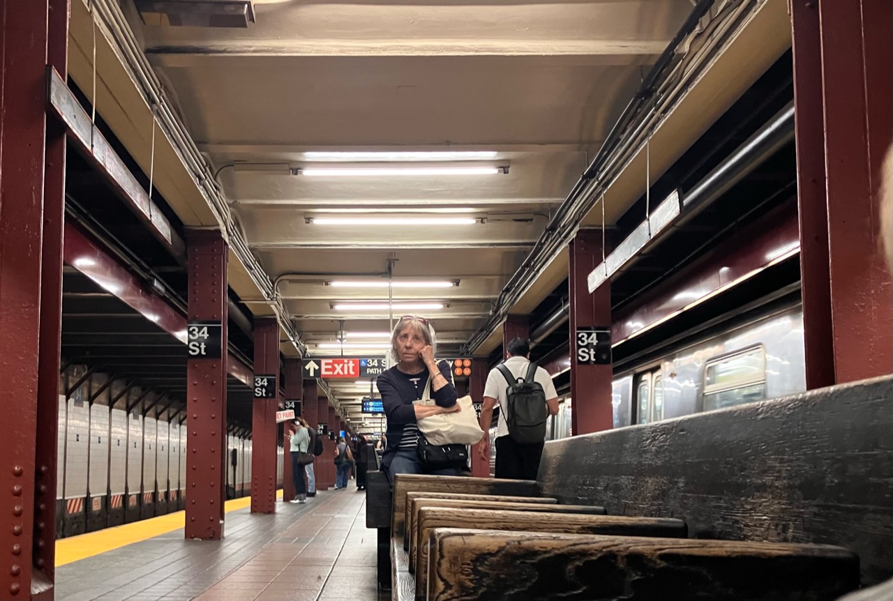 People waiting on a subway platform at 34th Street