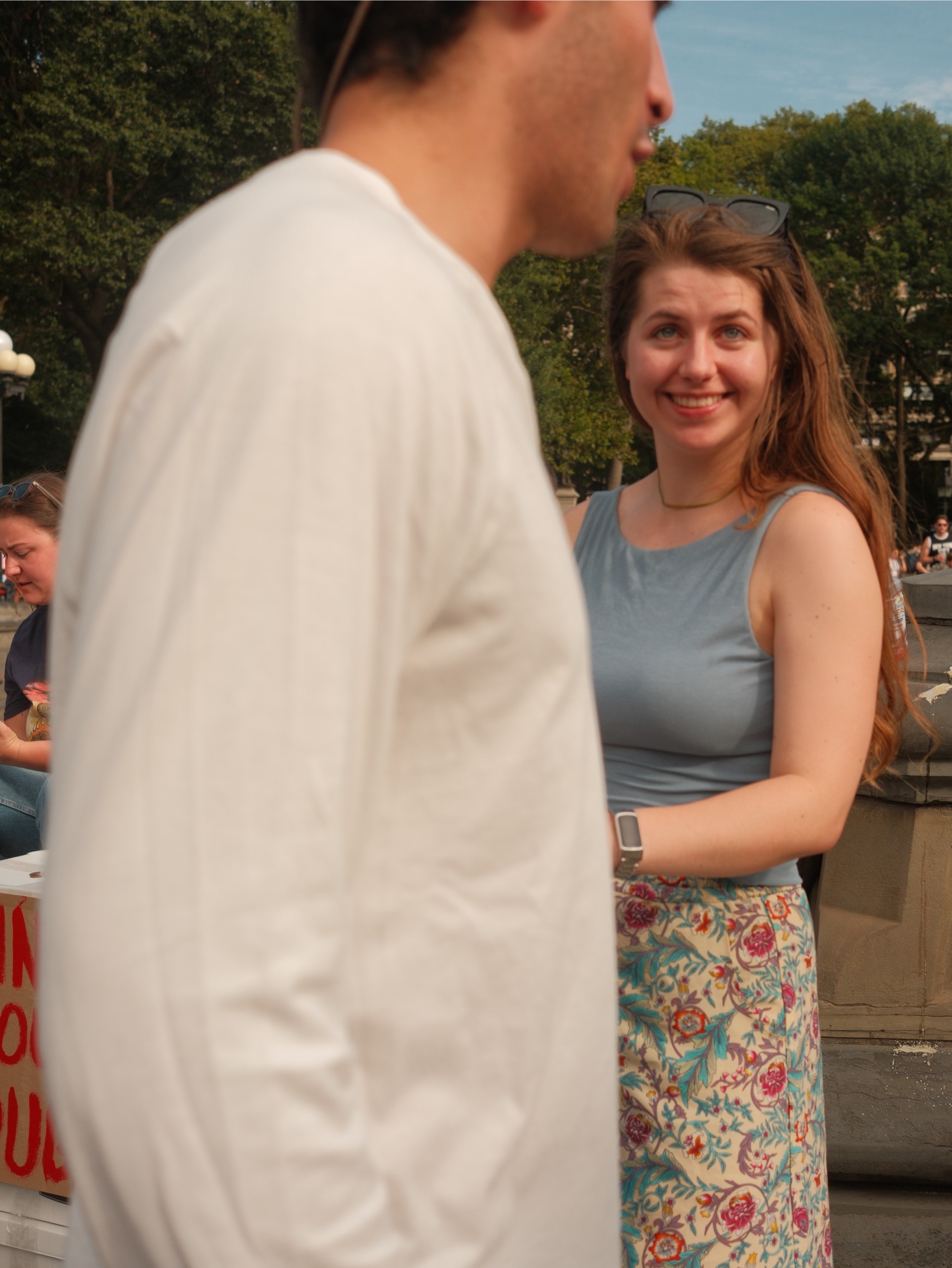 Two people talking in a sunny park